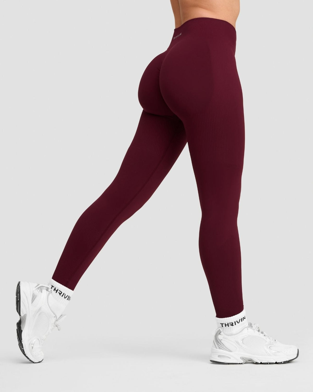 Elevate Sculpting Mid Waist Scrunch Leggings in Merlot, side view of leg mid-stride