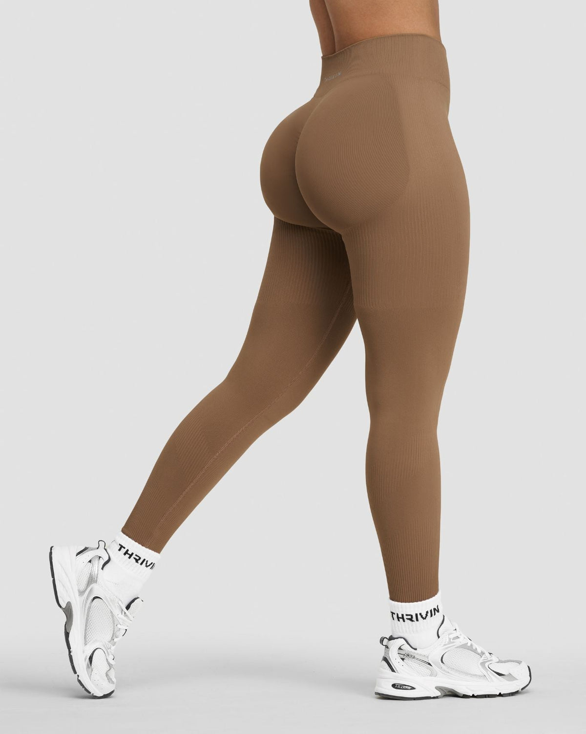 Elevate Sculpting Mid Waist Scrunch Leggings in Toffee, side view of leg mid-stride