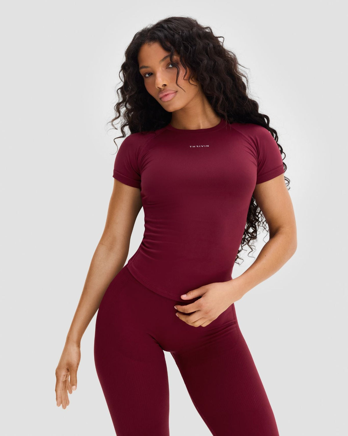 Elevate Compression T-Shirt in Fine Wine Red, three-quarter front view with short sleeves and matching leggings