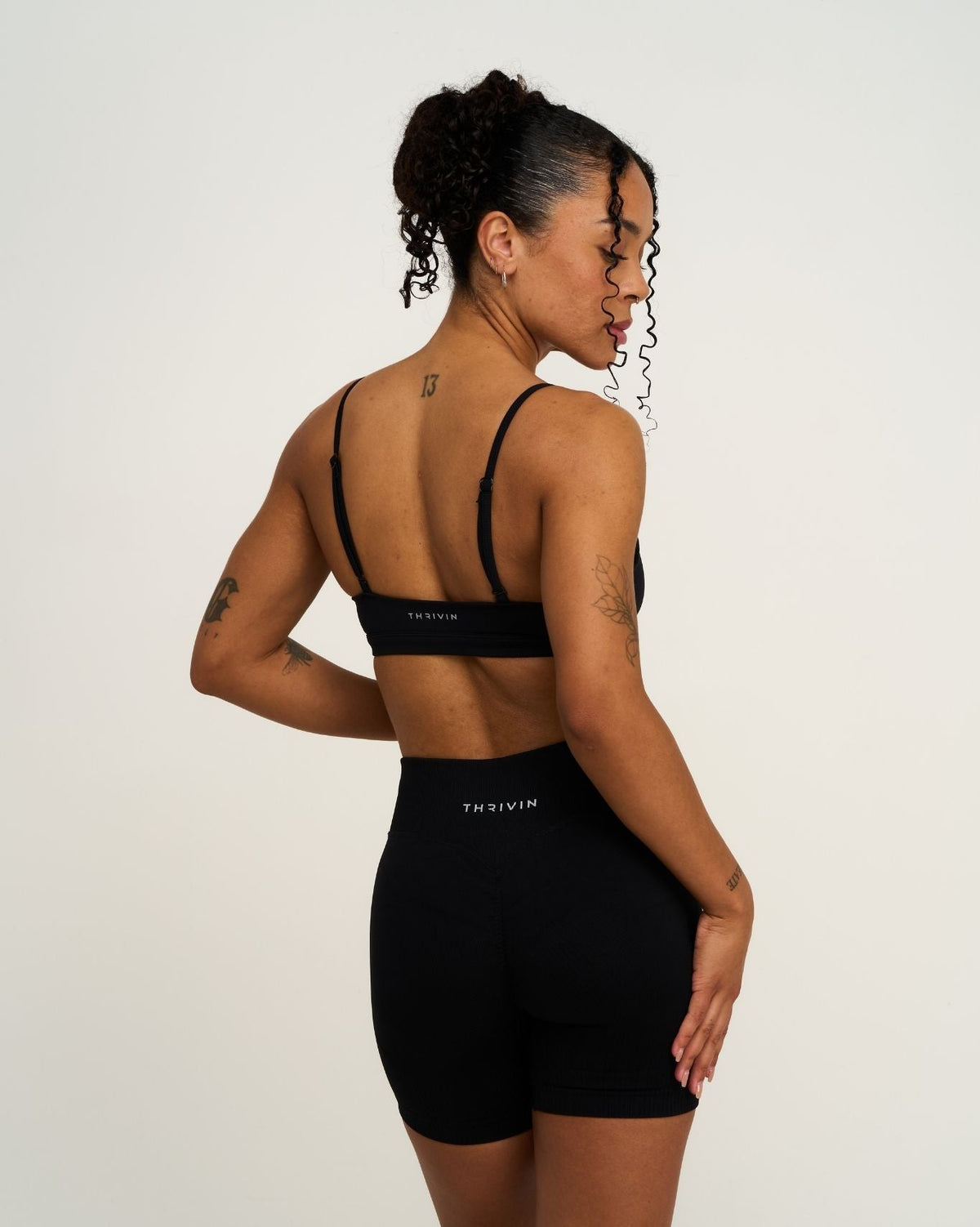 Elevate Sculpting Seamless Scoop Neck Bra in Night Black, back view with strappy back, styled with matching shorts