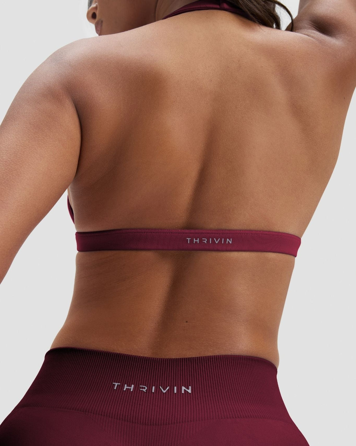 Elevate Sculpting Seamless V-Neck Halter Bra in Cherry Berry, back close-up of THRIVIN band and tie-back straps