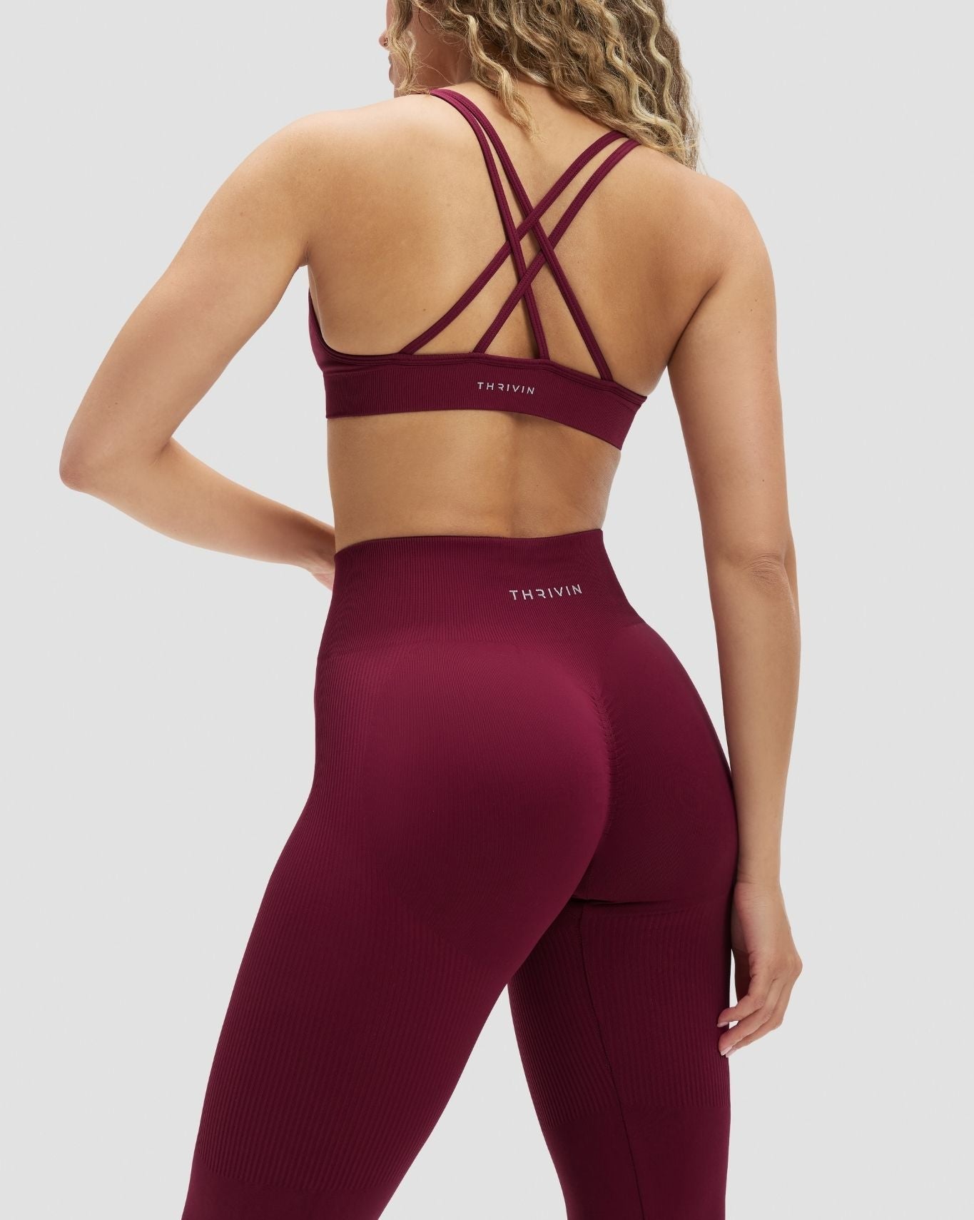 Elevate Sculpting Seamless High Apex Bra in Cherry Berry, back view with crossed straps and THRIVIN band
