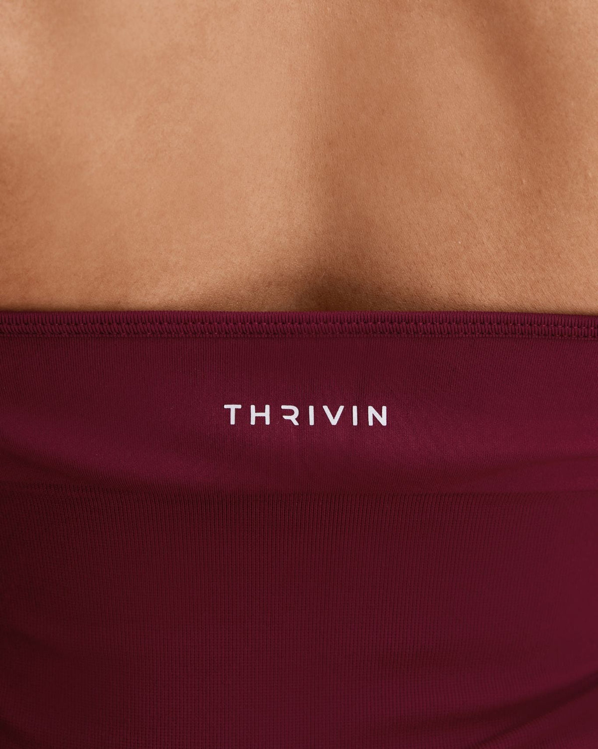 Elevate Sculpting Seamless Halterneck Top in Fine Wine Red, back close-up of band with THRIVIN logo