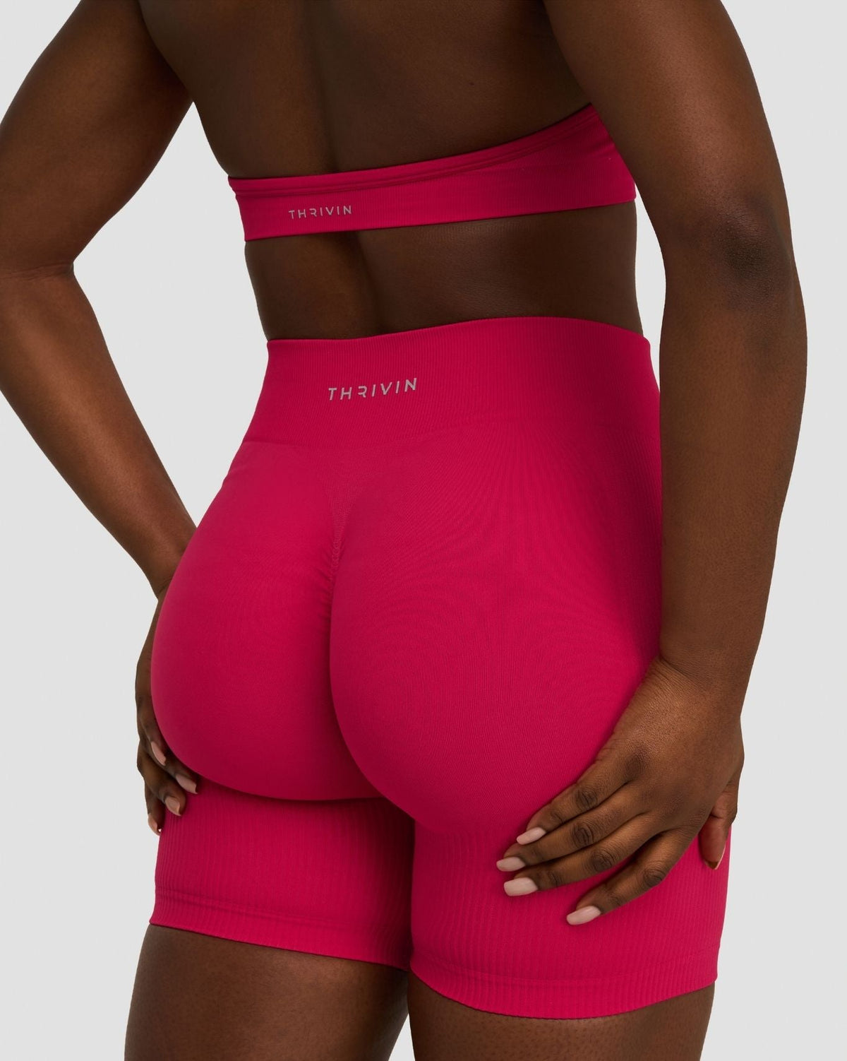 Elevate Sculpting Mid Waist Scrunch Shorts in Strawberry, back close-up of sculpted seat, styled with matching bra top
