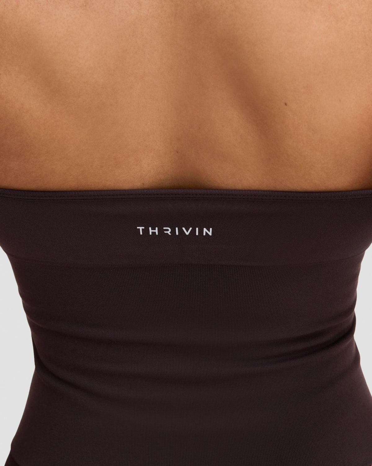Elevate Sculpting Seamless Halterneck Top in Coffee Brown, back close-up of THRIVIN logo band