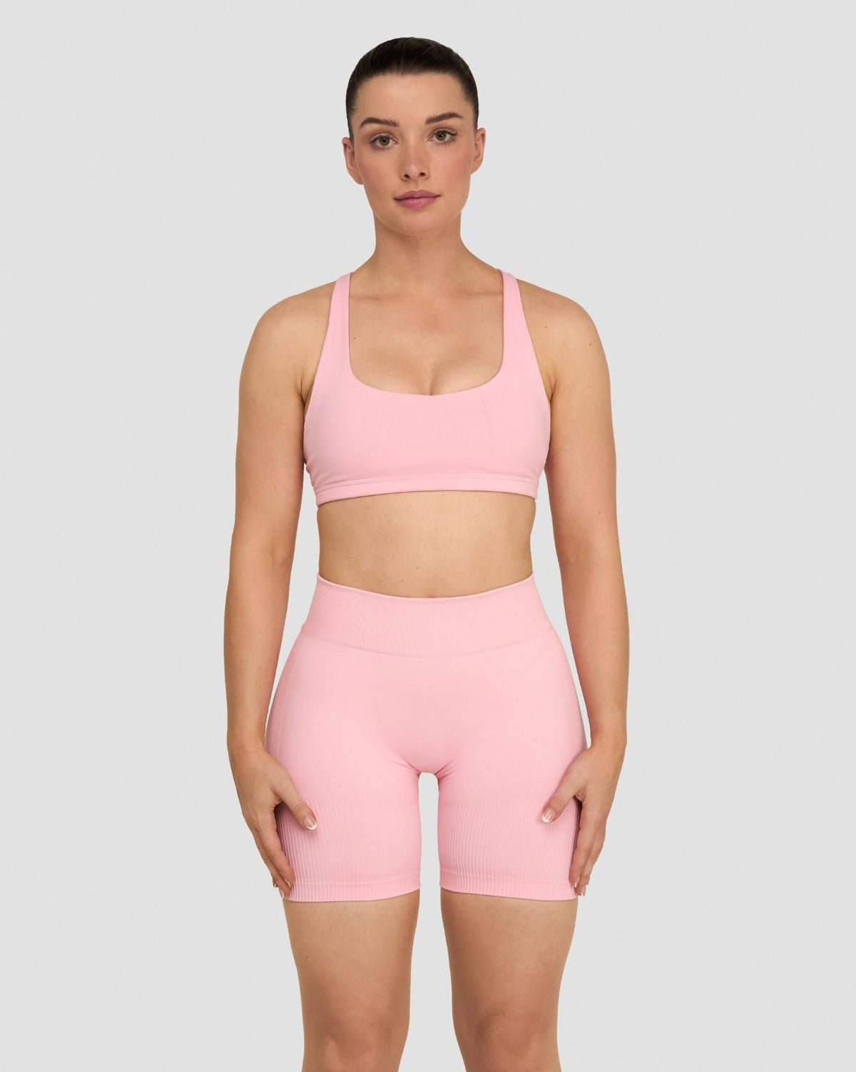 Elevate Sculpting Medium Impact Multiway Bra in Cotton Pink, front view styled with matching shorts