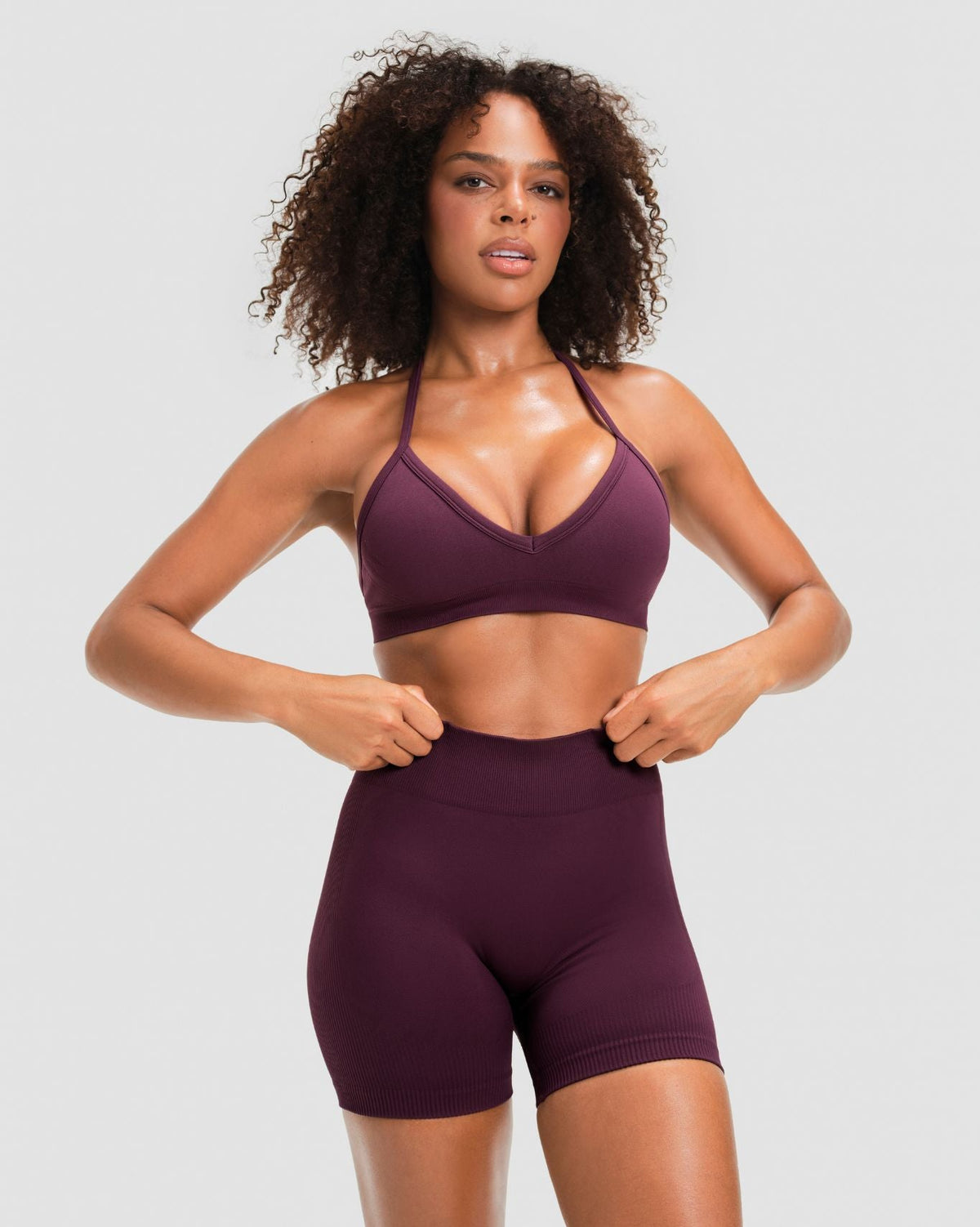 Elevate Sculpting Mid Waist Scrunch Shorter Shorts in Winter Plum Red, front view of mid waistband with matching halter bra