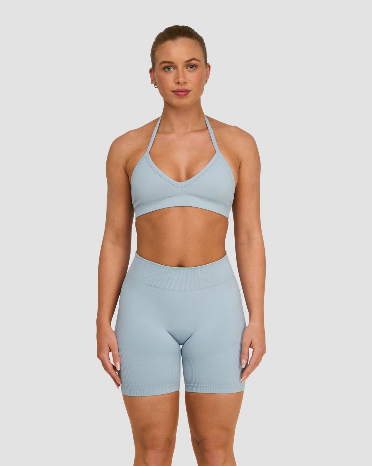 Elevate Sculpting Seamless Adjustable Halter Bra in Blue Haze, front view with plunge V-neck and halter straps