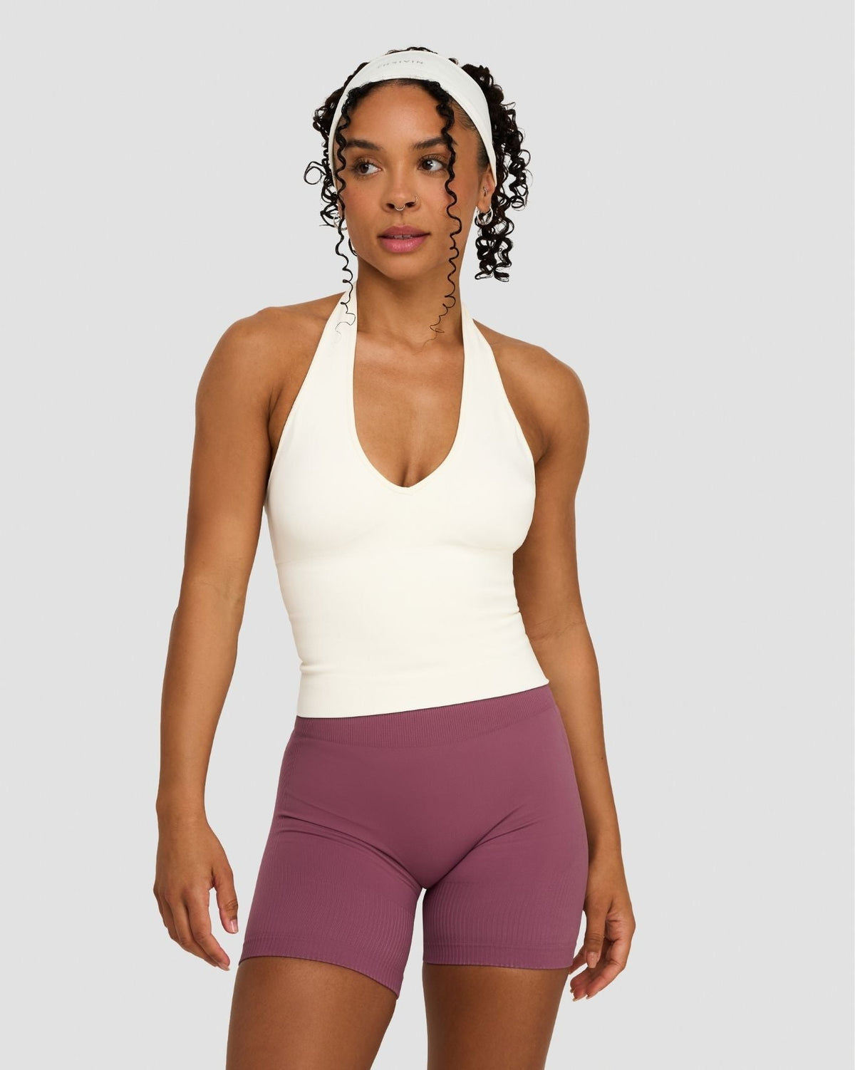 Elevate Sculpting Seamless Halterneck Top in Cream, front view, hand on hip