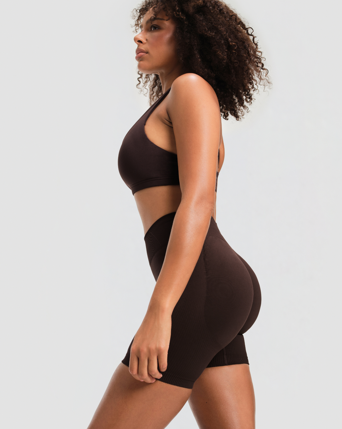Elevate Sculpting Mid Waist Scrunch Shorts in Coffee Brown, side view of the mid waist and scrunch shaping