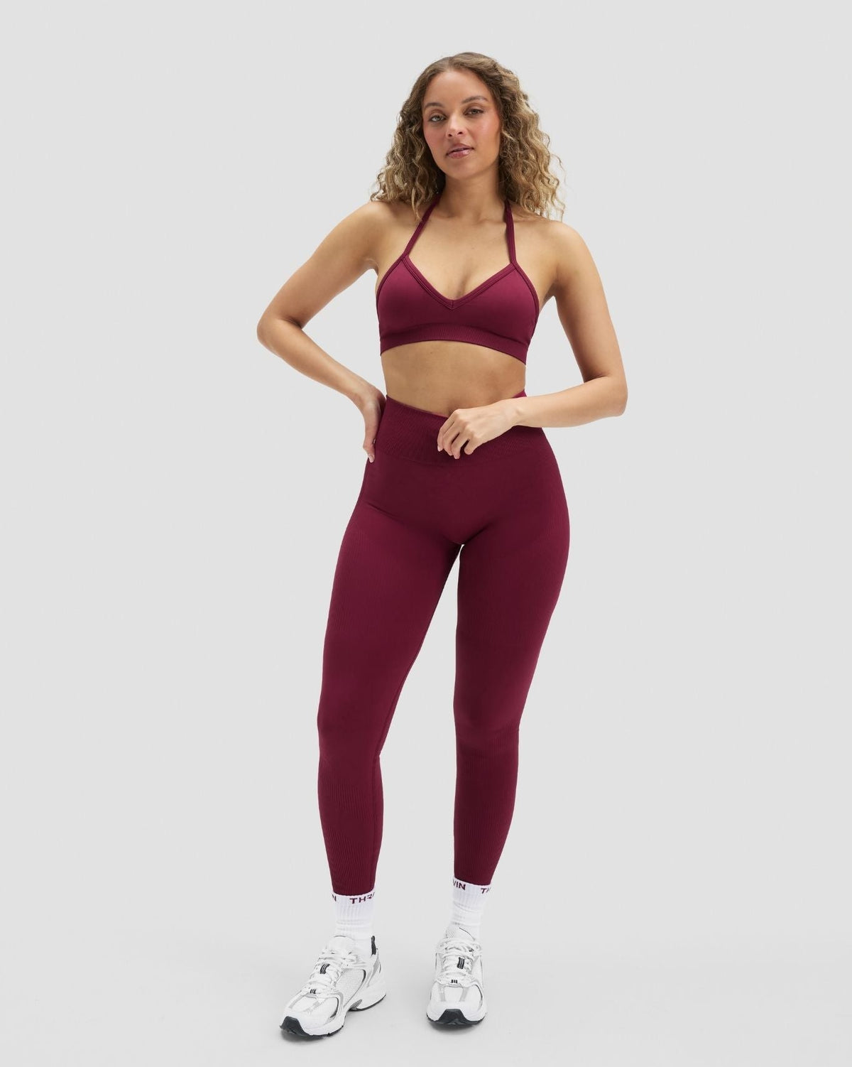 Elevate Sculpting High Waist Scrunch Leggings in Cherry Berry, front view styled with matching halter bra, hand on hip