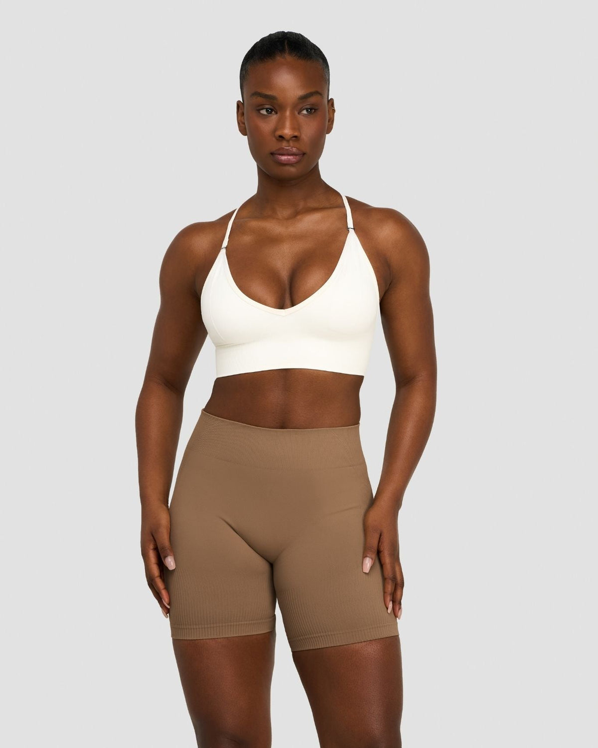 Elevate Multiway Sculpt Seamless Bra in Cream, front view styled with shorts