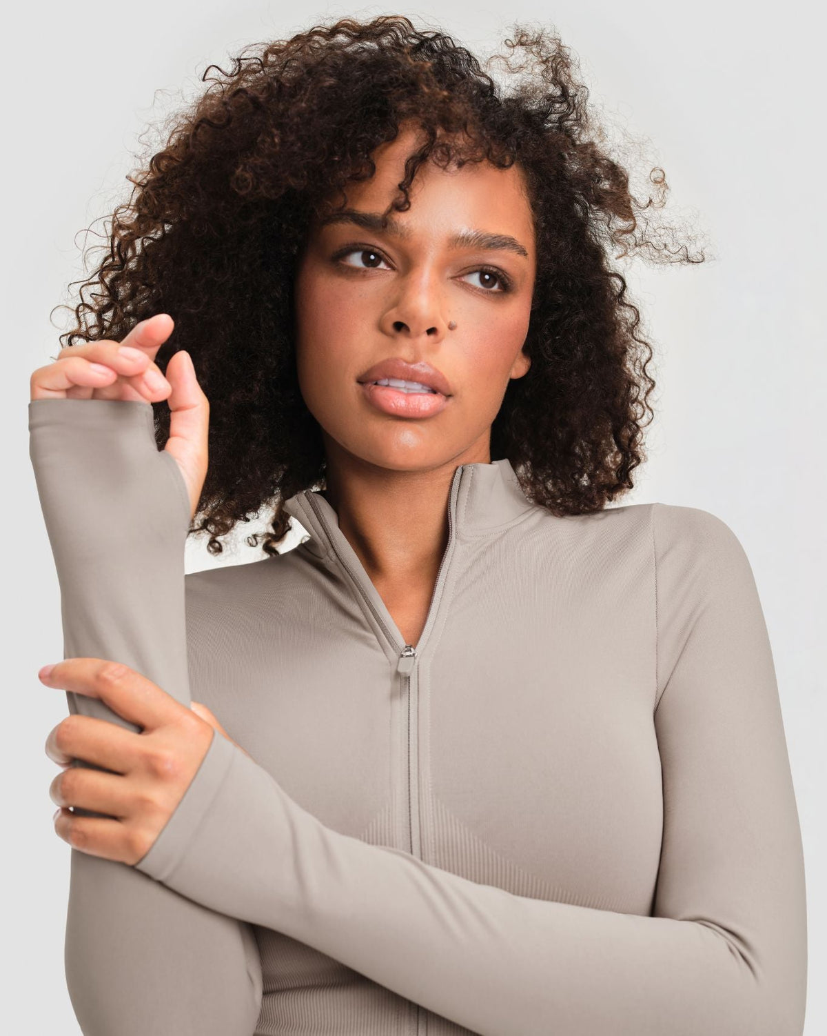 Elevate Compression Long Sleeve Jacket in Latte Grey, close-up of stand collar, zip and thumbholes