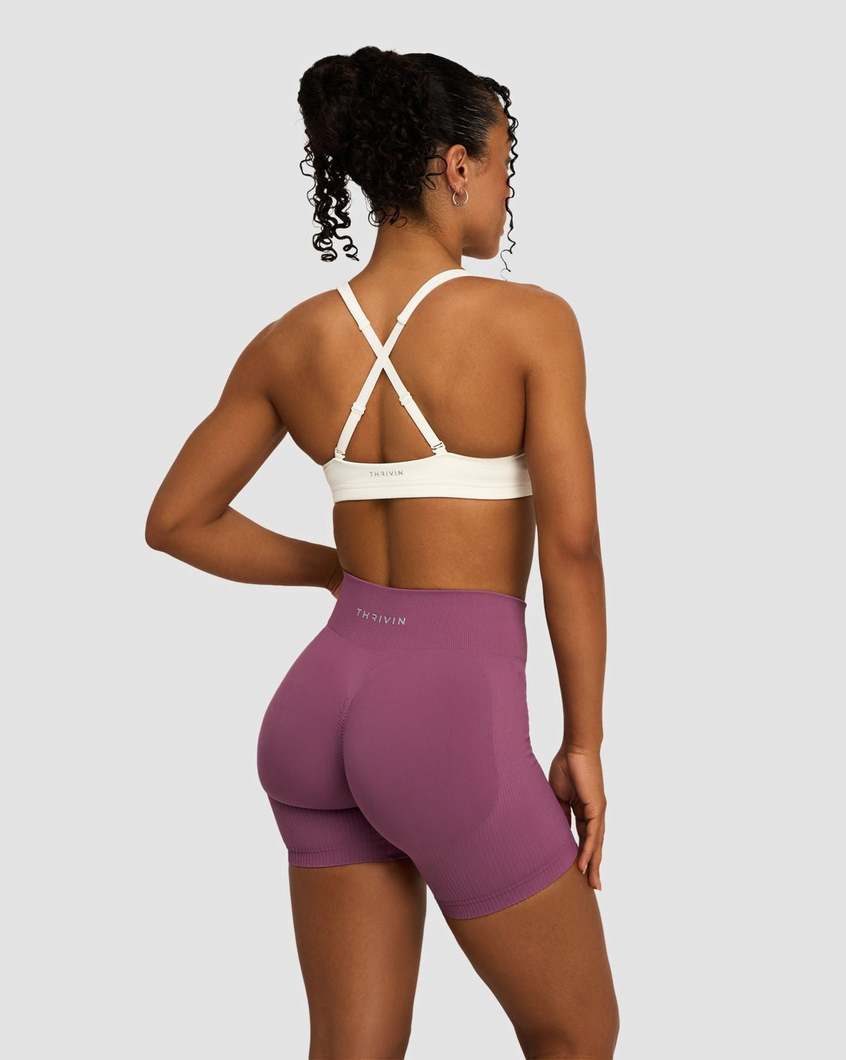 Elevate Sculpting Mid Waist Scrunch Shorts in Orchid Mauve, back view styled with cream crossover back bra