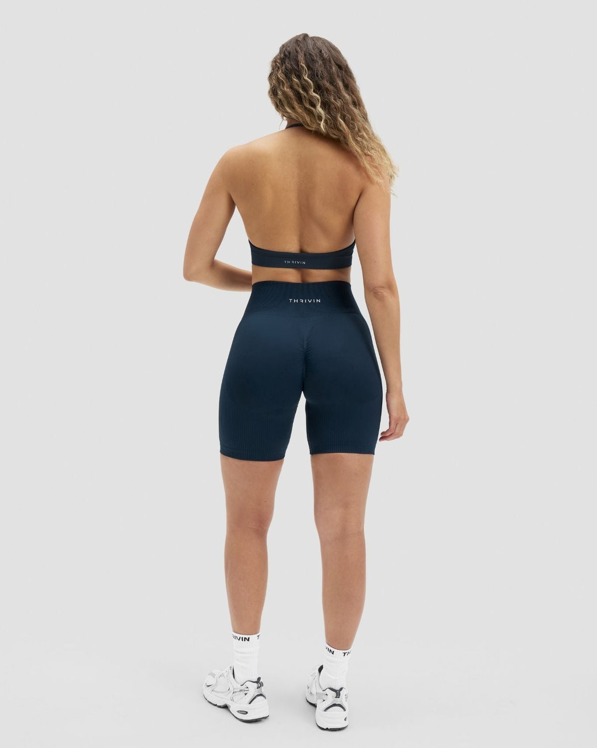 Elevate Sculpting High Waist Scrunch Shorts in Midnight Navy Blue, full-length back view