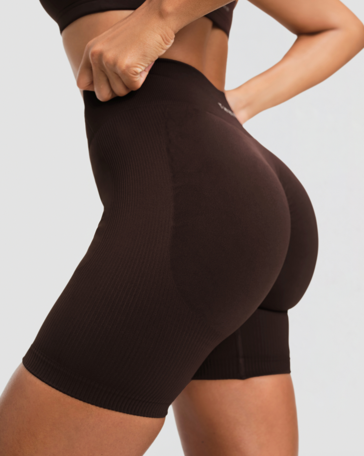Elevate Sculpting Mid Waist Scrunch Shorts in Coffee Brown, side close-up of ribbed sculpting knit and high-compression fit