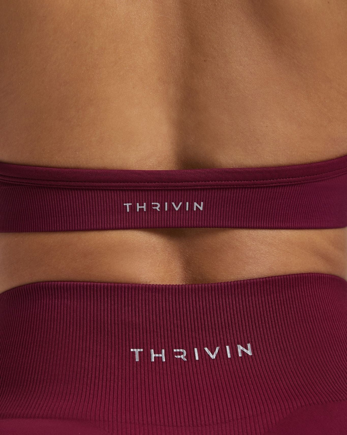 Elevate Sculpting Seamless Adjustable Halter Bra in Cherry Berry, back close-up of THRIVIN logo band