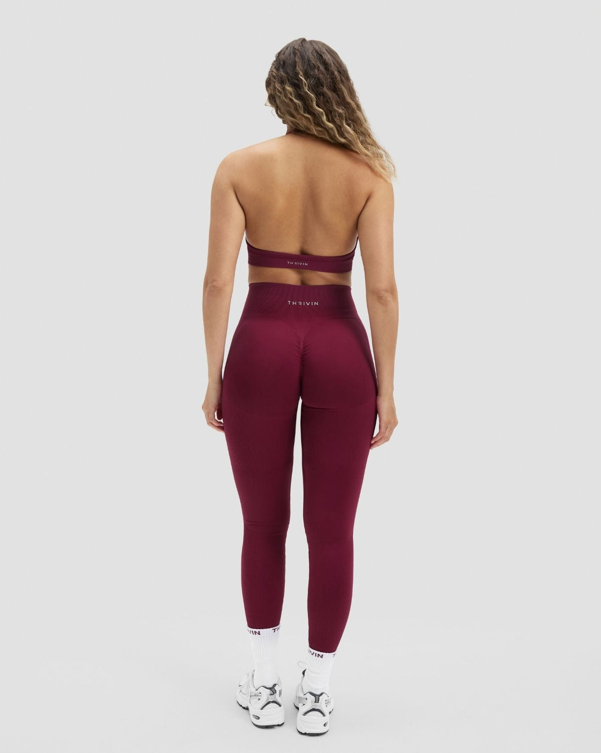 Elevate Sculpting High Waist Scrunch Leggings in Cherry Berry, back view with matching strappy halter bra, standing