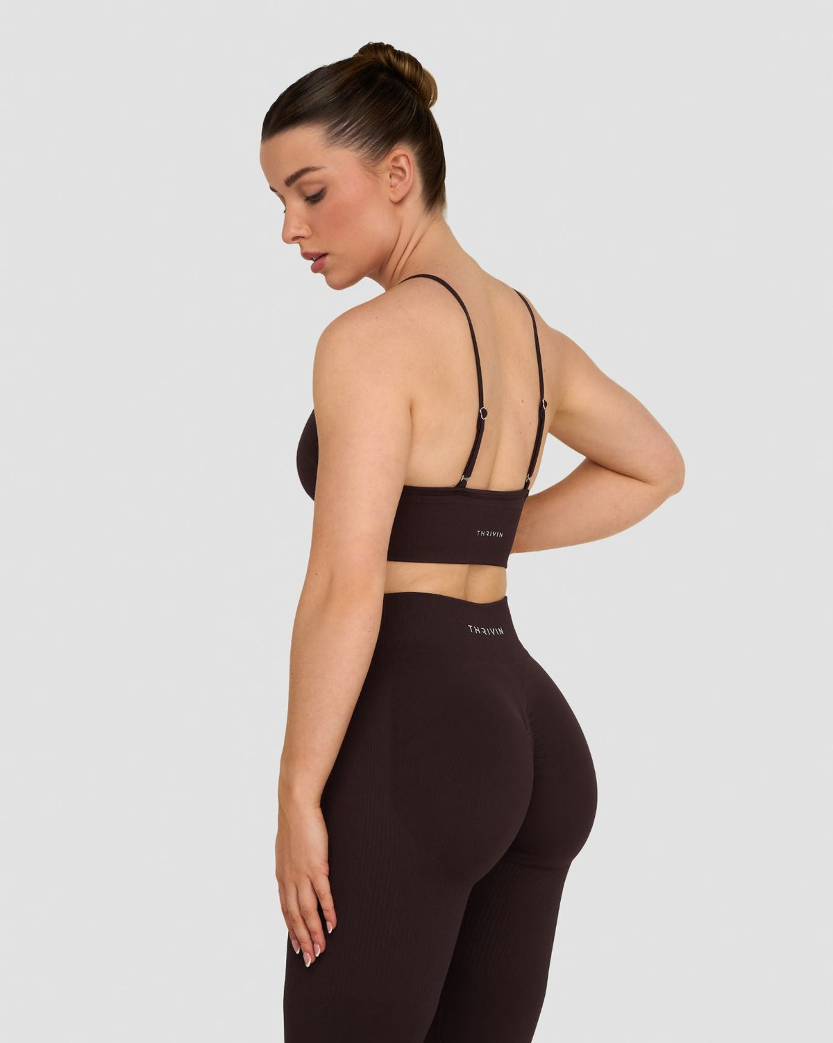 Elevate Multiway Sculpt Seamless Bra in Coffee Brown, side back view with crisscross straps, styled with leggings