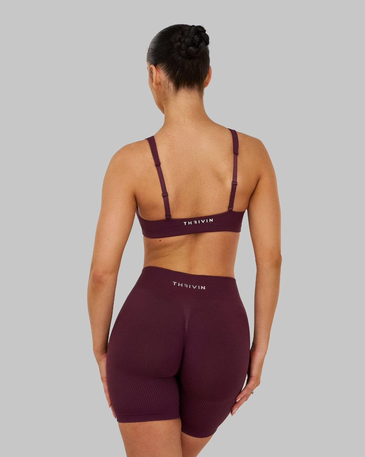 Elevate Sculpting Medium Impact Multiway Bra in Winter Plum Red, back view styled with shorts