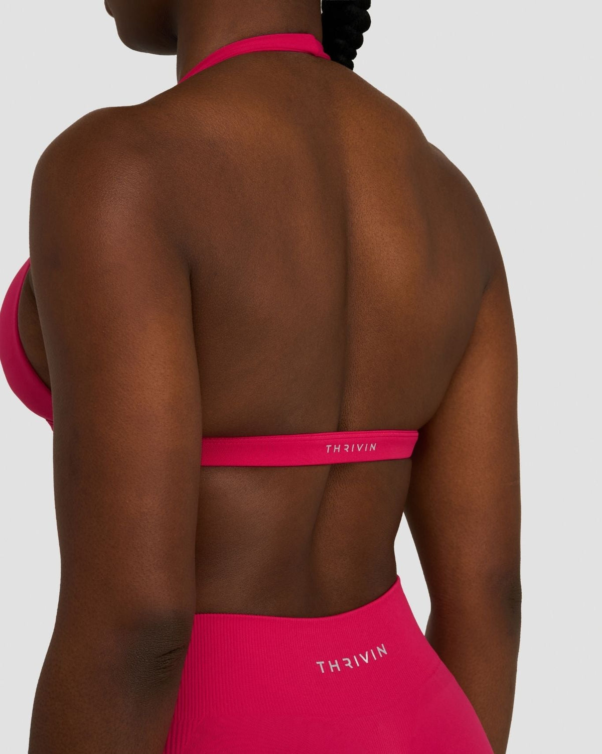 Elevate Sculpting Seamless V-Neck Halter Bra in Strawberry, back close-up from the side, band with THRIVIN logo