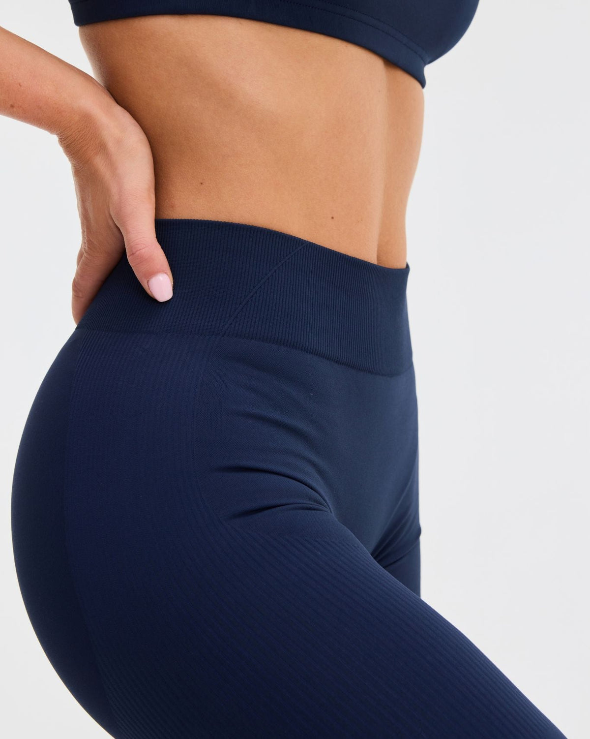Elevate Sculpting Mid Waist Scrunch Leggings in Midnight Navy Blue, side close-up of high waistband and curved seam