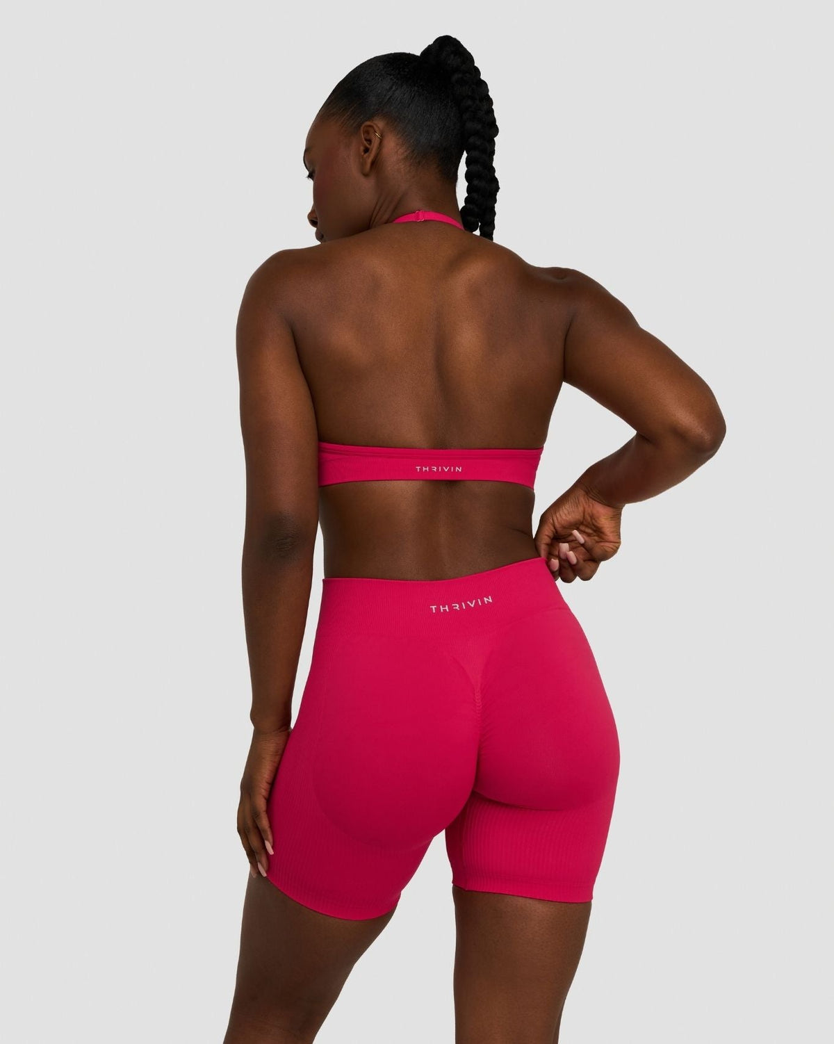 Elevate Sculpting Mid Waist Scrunch Shorts in Strawberry, back view with hands on hips, styled with matching bra top