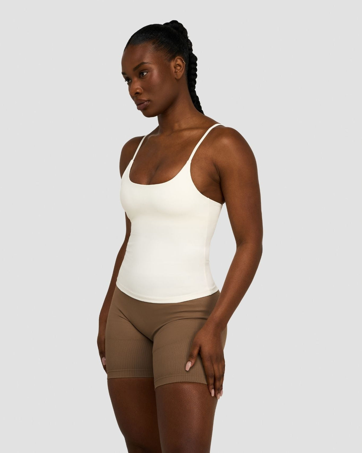 Elevate Sculpting Seamless Scoop Neck Cami in Cream, three-quarter front view with scoop neck, styled with brown shorts