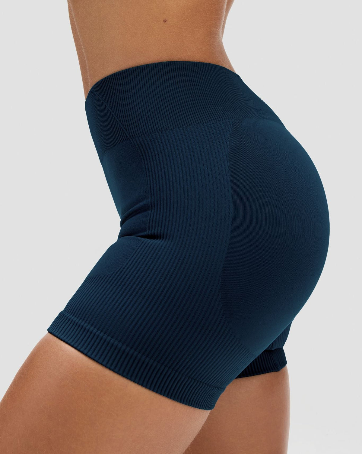 Elevate Sculpting Mid Waist Scrunch Shorter Shorts in Midnight Navy Blue, side close-up of ribbed sculpting knit and hem