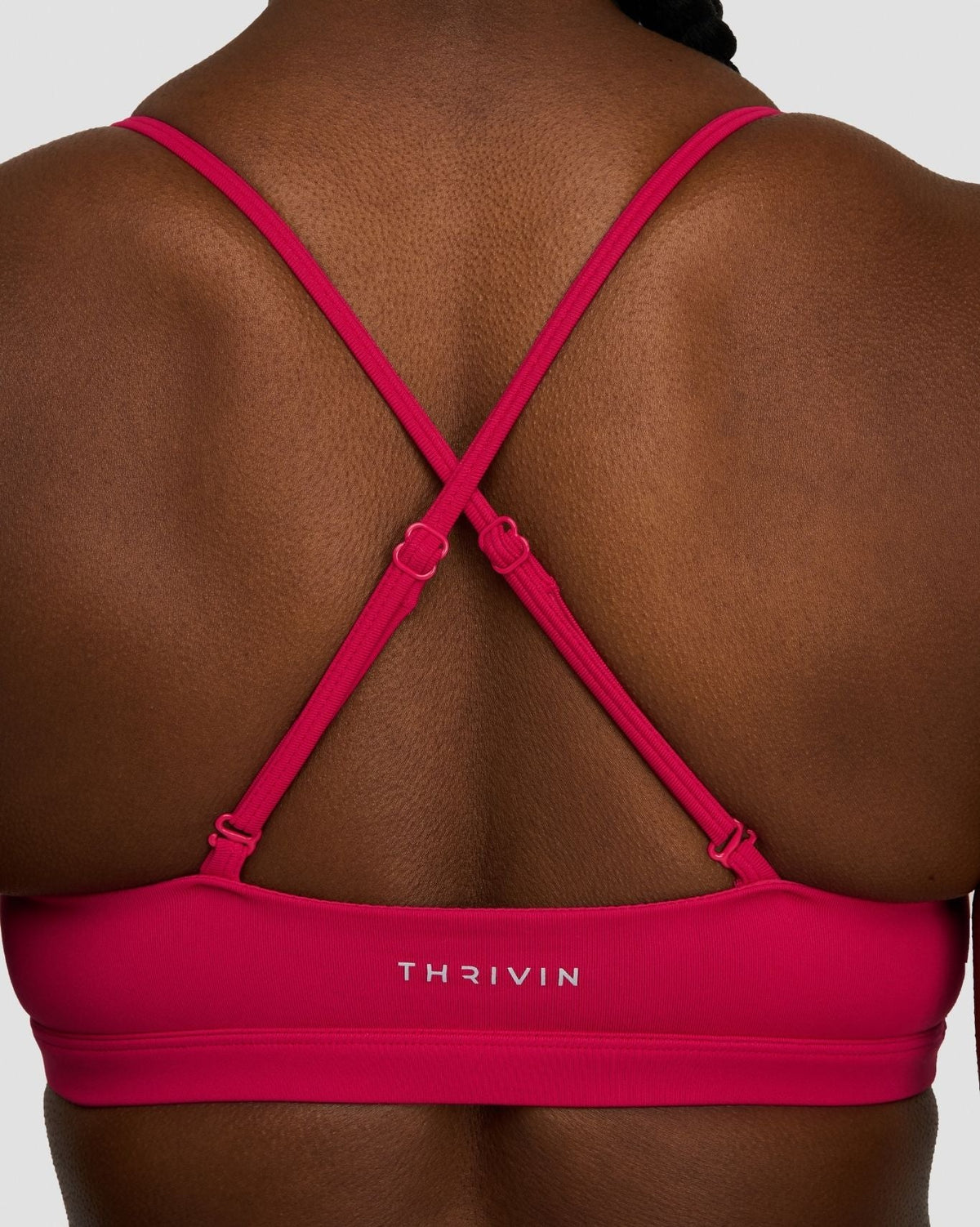 Elevate Sculpting Seamless Scoop Neck Bra in Strawberry, back close-up of crossover straps and THRIVIN logo band