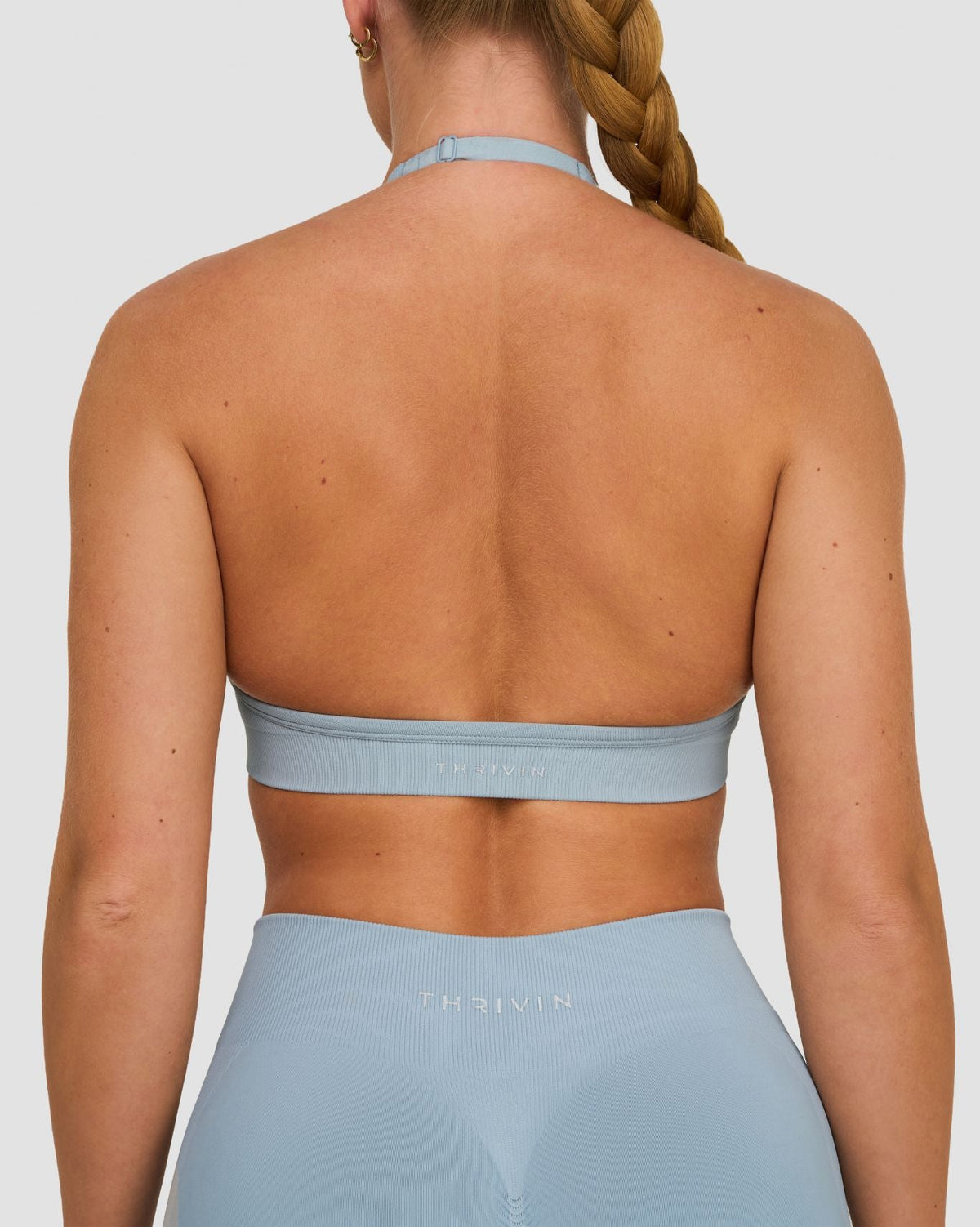 Elevate Sculpting Seamless Adjustable Halter Bra in Blue Haze, back close-up of halter clasp and THRIVIN logo