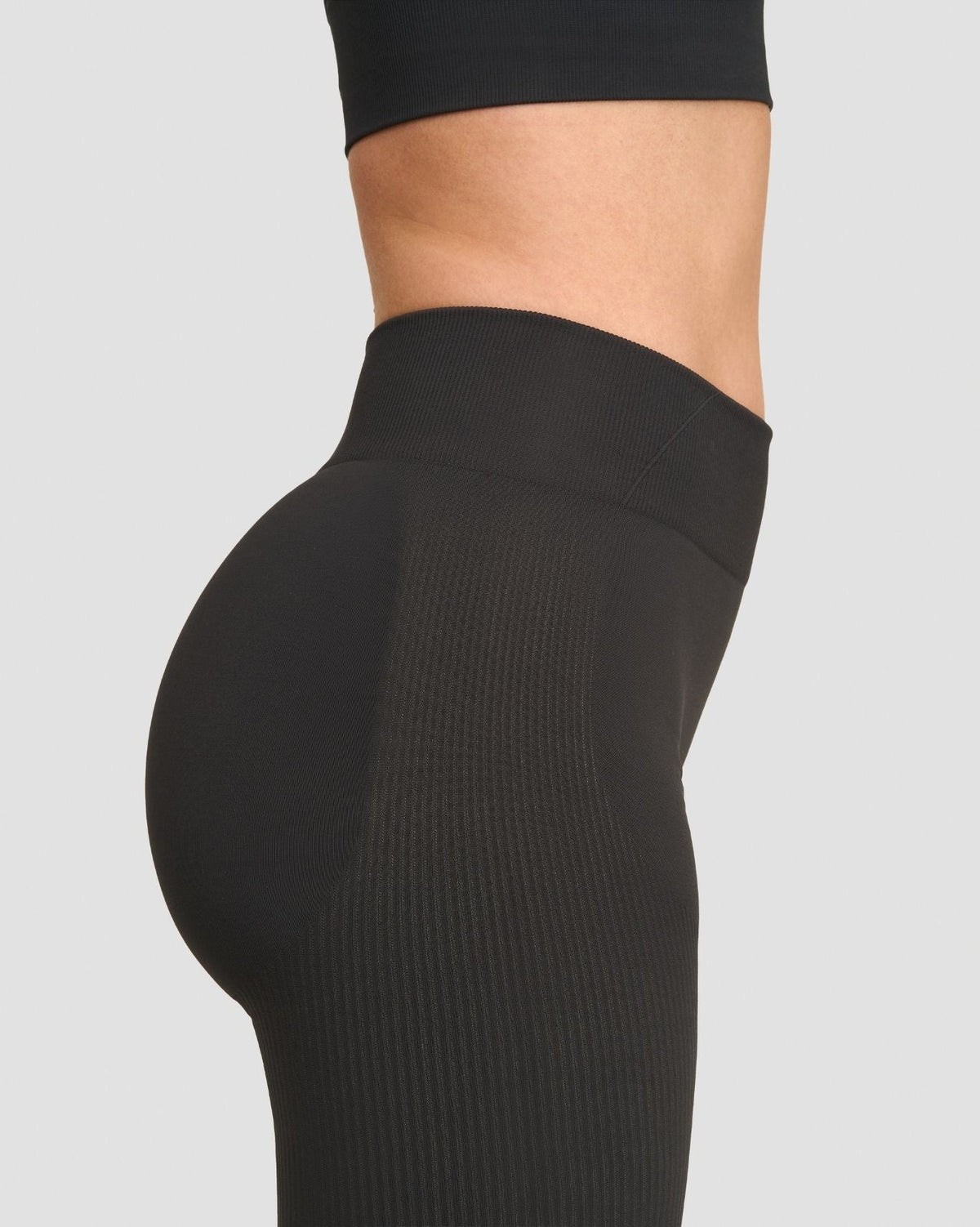 Elevate Sculpting Mid Waist Scrunch Leggings in Charcoal Grey, side close-up of waistband and scrunch seam in ribbed knit