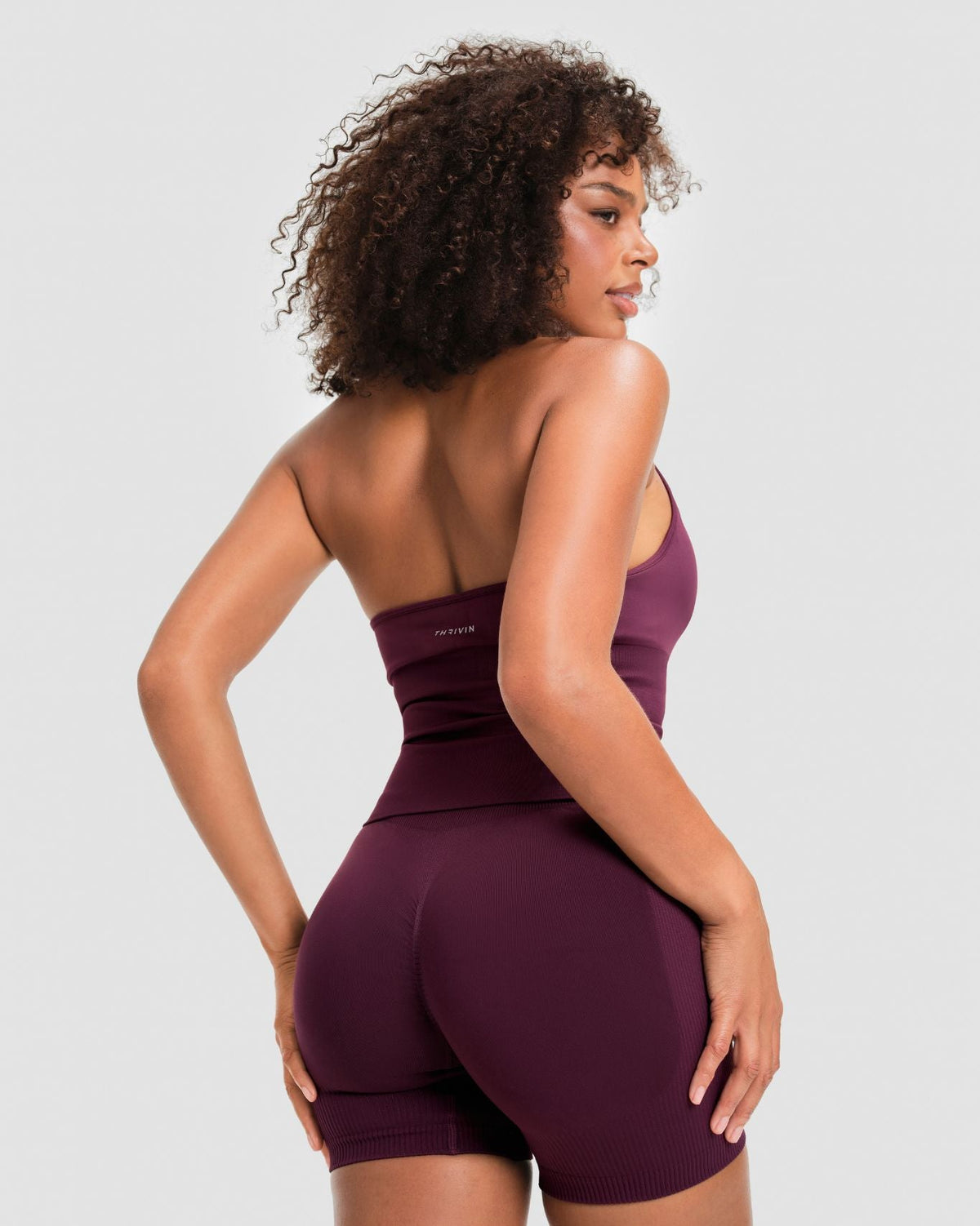 Elevate Sculpting Seamless Halterneck Top in Winter Plum Red, back view with open back, THRIVIN logo and matching shorts