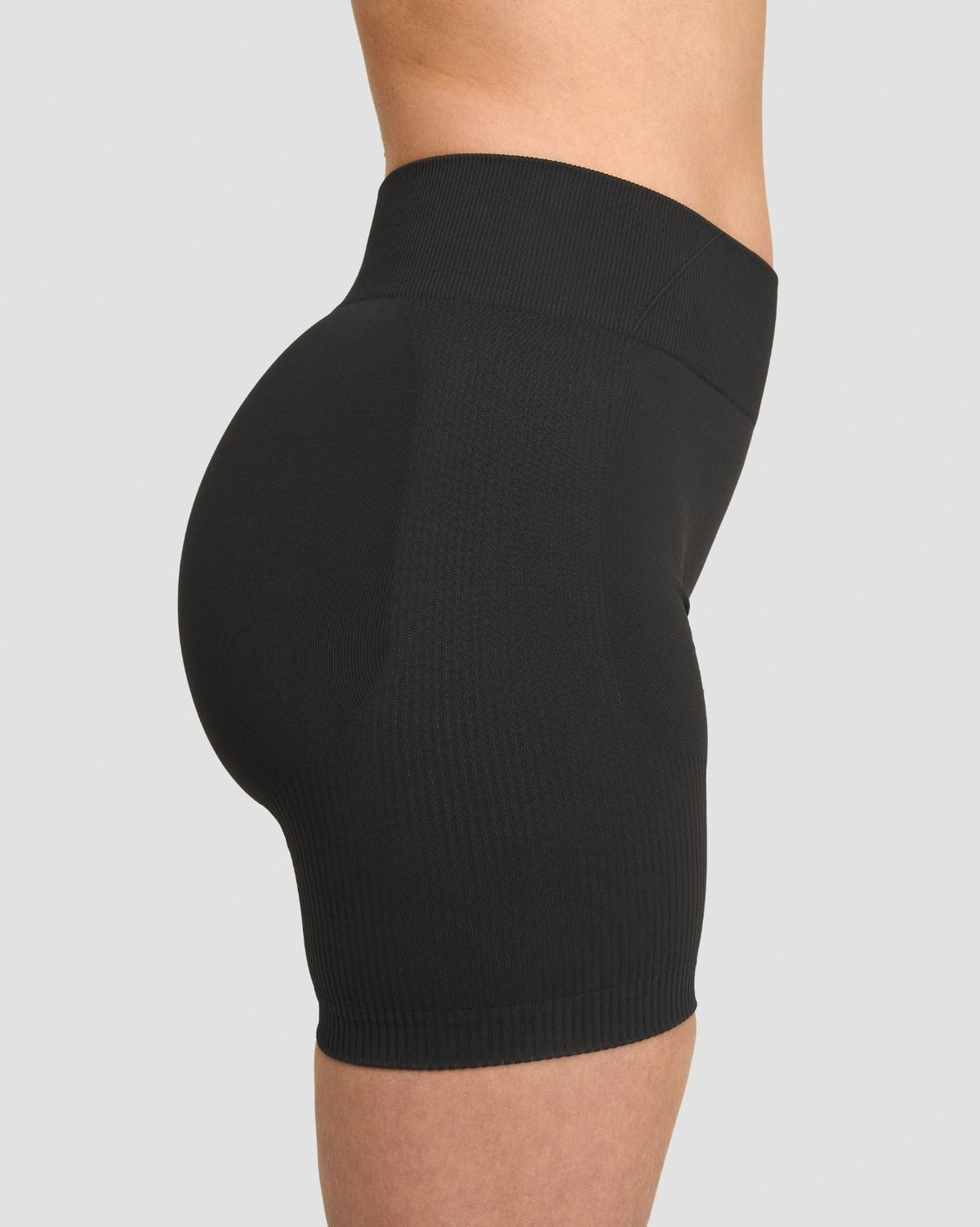 Elevate Sculpting Mid Waist Scrunch Shorts in Charcoal Grey, side close-up of waistband and sculpted fit