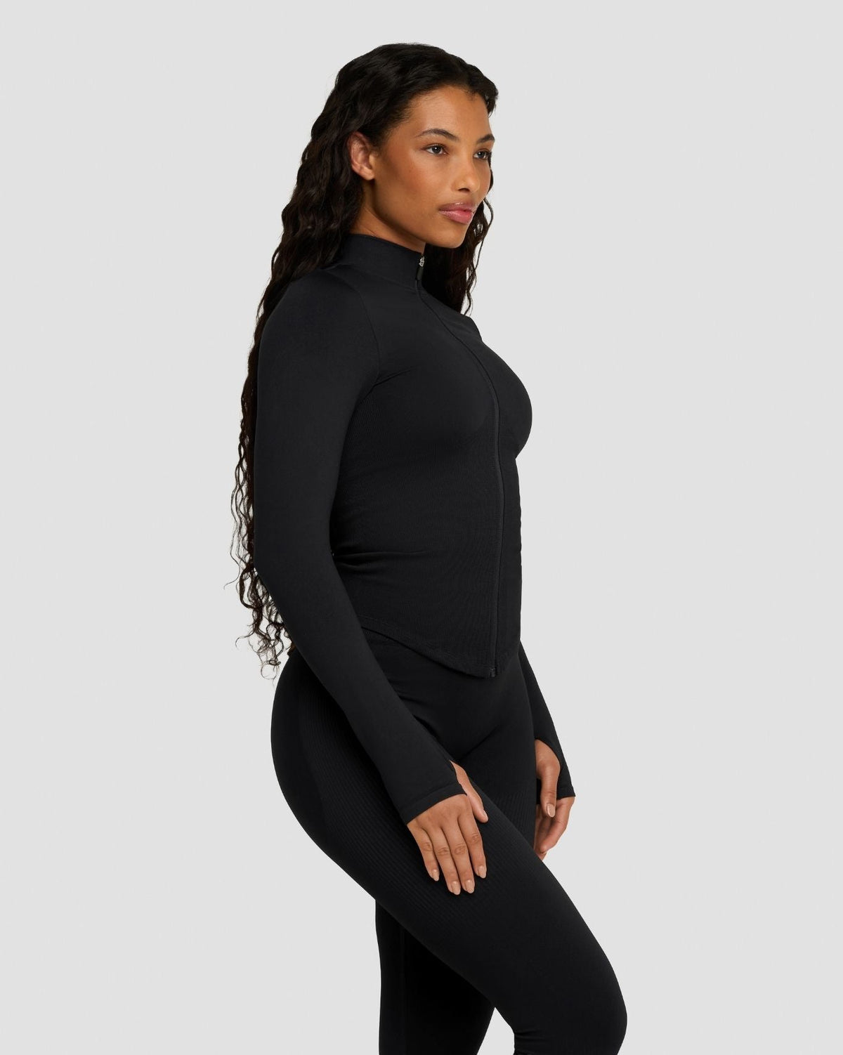 Elevate Compression Long Sleeve Jacket in Night Black, side view with thumbhole cuff