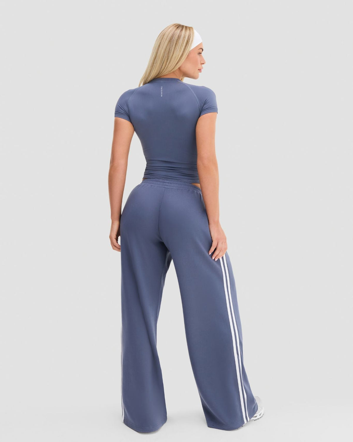 Elevate Compression T-Shirt in Steel Blue, full-length back view of vertical Thrivin logo and raglan sleeves