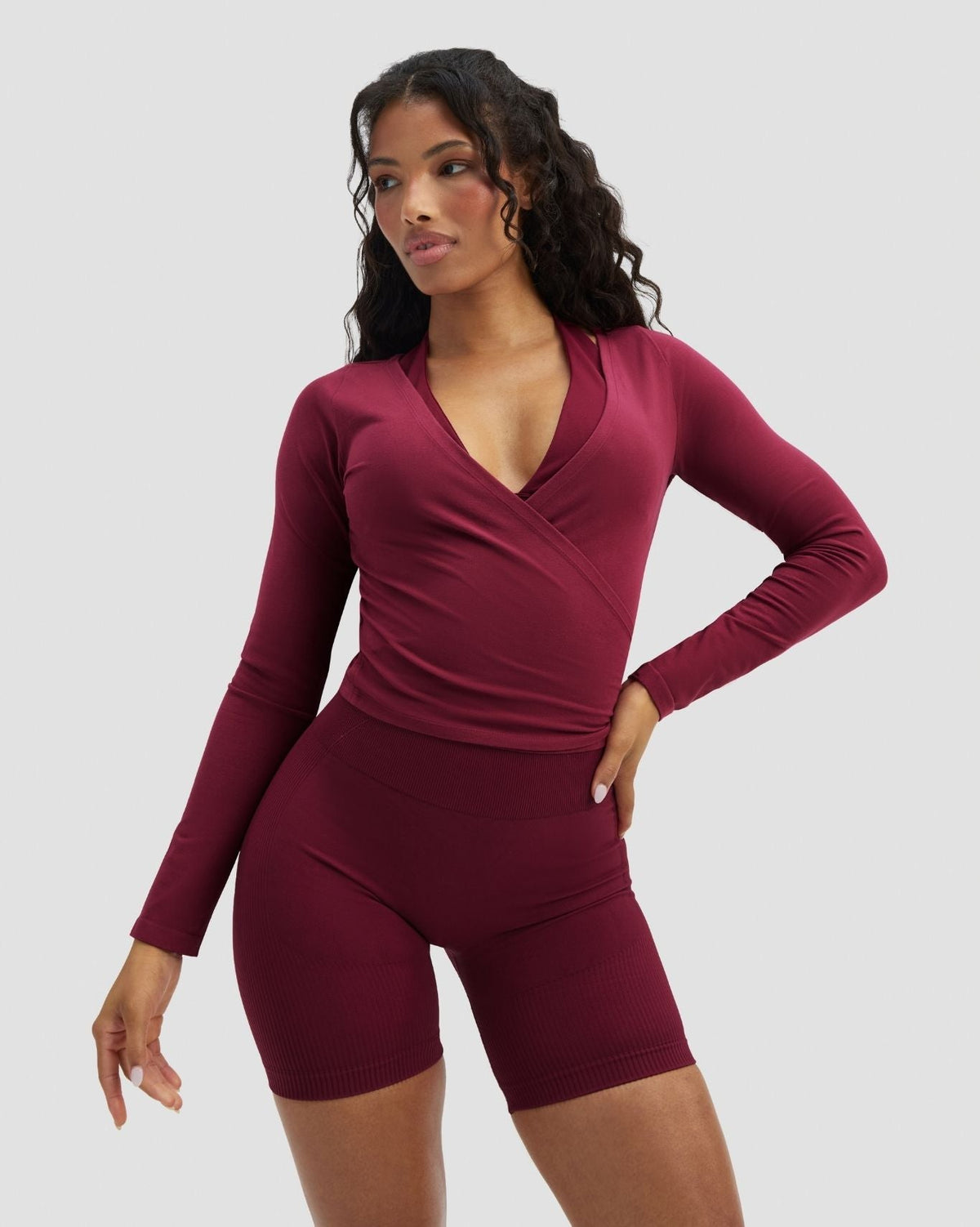 The Essential Collection Wrap Top in Cherry Berry, front view with wrap V-neck and long sleeves