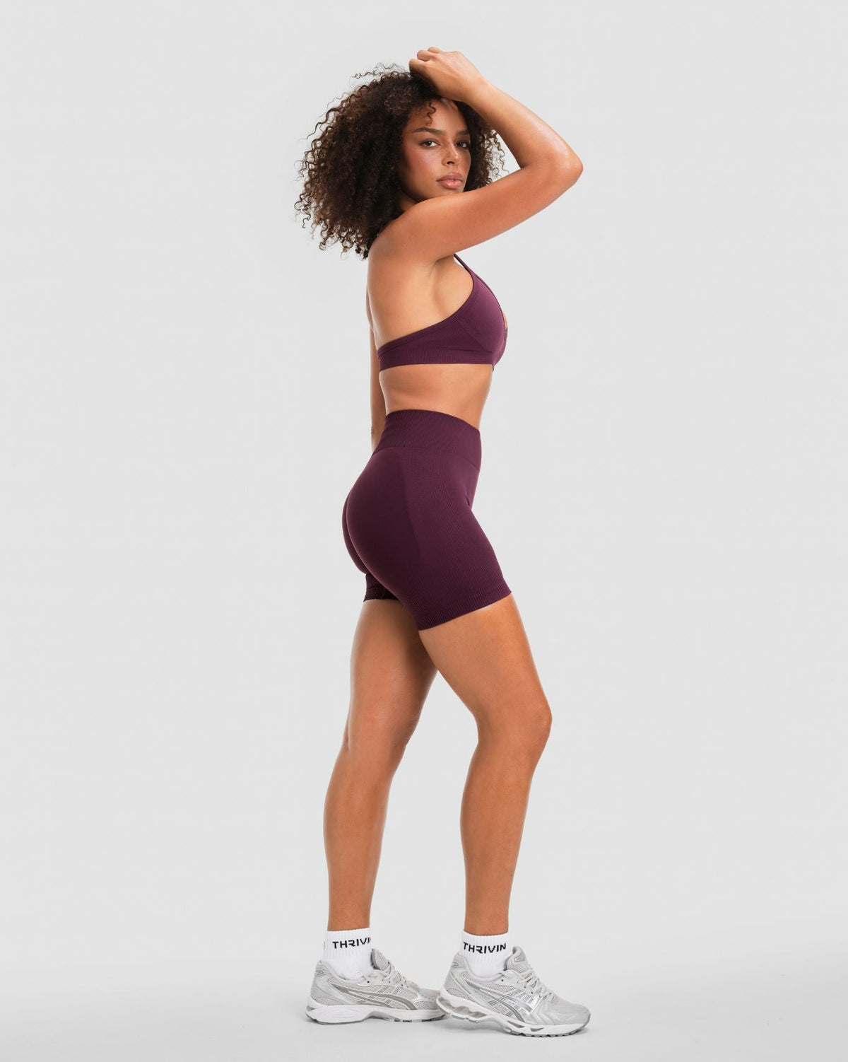 Elevate Sculpting Mid Waist Scrunch Shorter Shorts in Winter Plum Red, three-quarter back view with shorter inseam