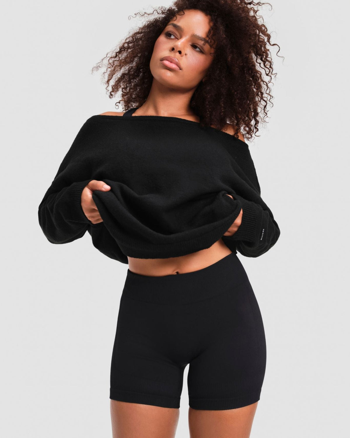 The Essential Collection Off The Shoulder Wool Blend Sweater in Night Black, front view with the hem gathered up
