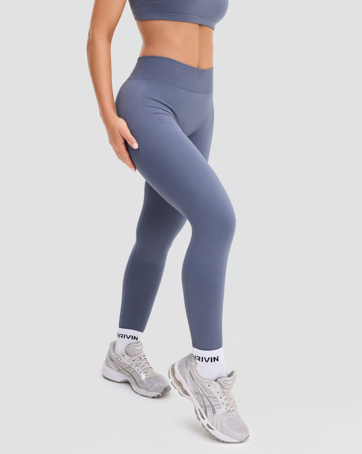 Elevate Sculpting Mid Waist Scrunch Leggings in Steel Blue, three-quarter front view from the waist down with ribbed knit