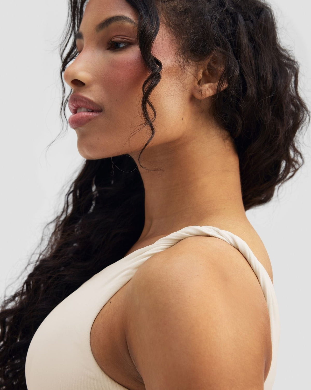 Elevate Sculpting Asymmetric Twist Top in Cream, close-up of side profile and strap