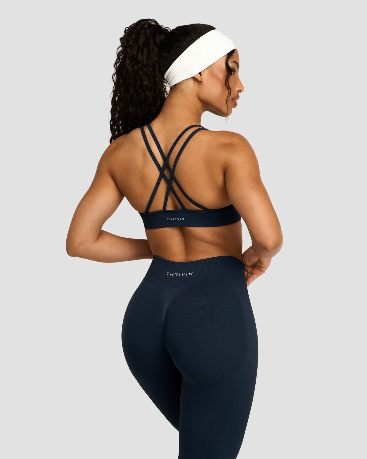 Elevate Sculpting Seamless High Apex Bra in Midnight Navy Blue, back view of crisscross straps, with matching leggings