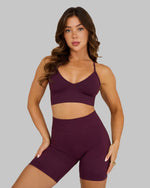 Elevate Multiway Sculpt Seamless Bra in Winter Plum Red, front view styled with shorts