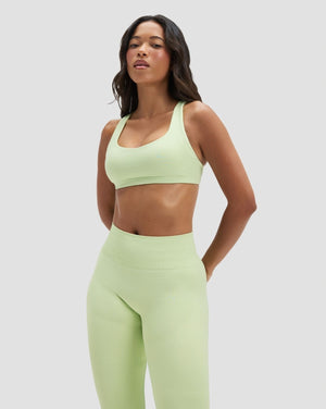 Elevate Sculpting Medium Impact Multiway Bra in Pistachio Green, front view of scoop neckline styled with matching leggings
