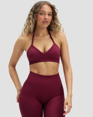Elevate Sculpting Seamless Adjustable Halter Bra in Cherry Berry, front view styled with leggings