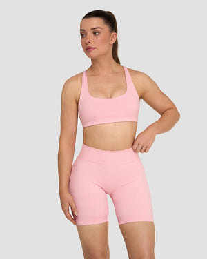 Elevate Sculpting Medium Impact Multiway Bra in Cotton Pink, front view with scoop neckline styled with shorts
