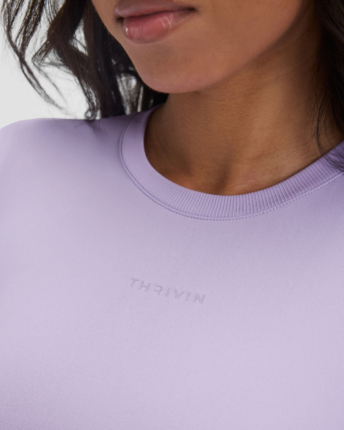 Elevate Compression Long Sleeve Top in Lilac, front close-up of crew neckline and Thrivin logo