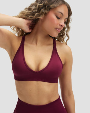 Elevate Sculpting Seamless High Apex Bra in Cherry Berry, front view with plunge V-neck and hand behind neck