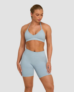 Elevate Sculpting Seamless Adjustable Halter Bra in Blue Haze, front view with V-neckline and halter neck