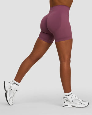 Elevate Sculpting Mid Waist Scrunch Shorts in Orchid Mauve, side view mid-stride, scrunch seam at back